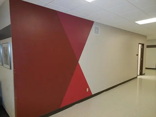 Interior hallway finished with a geometric maroon wall pattern