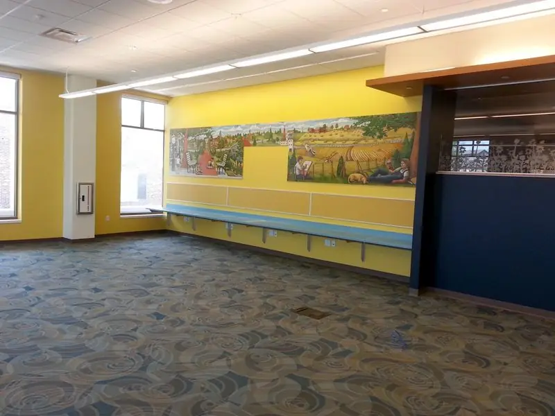 Lobby with a painted wall mural and patterned carpet