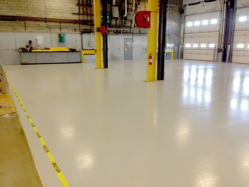 Bright shop floor coated in white epoxy with safety striping