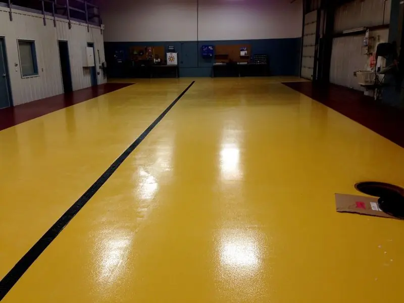 Glossy yellow epoxy floor with a black line running down the middle
